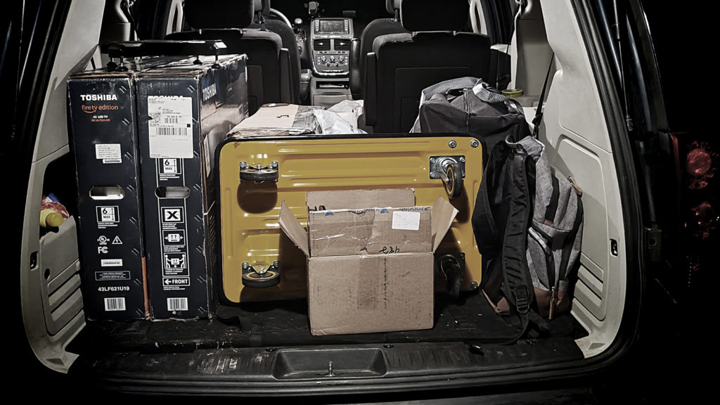 Van packed with various cargo, trolley, TV-s in boxes and backpacks