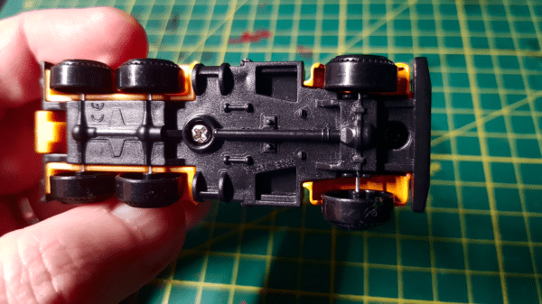 A photo of a Teamsterz brand diecast car, showing the screws you can use to take it apart to paint it for Gaslands.